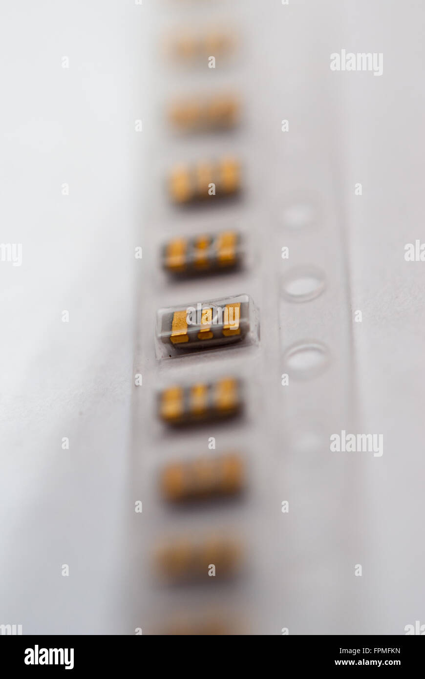 Package of smd capacitors (Murata brand) on a white background closeup. Stock Photo