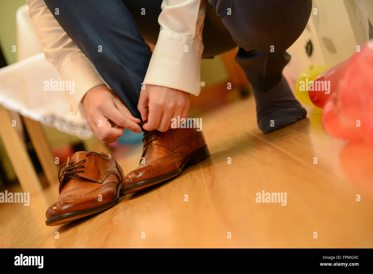Man tied shoelace in natural light Stock Photo