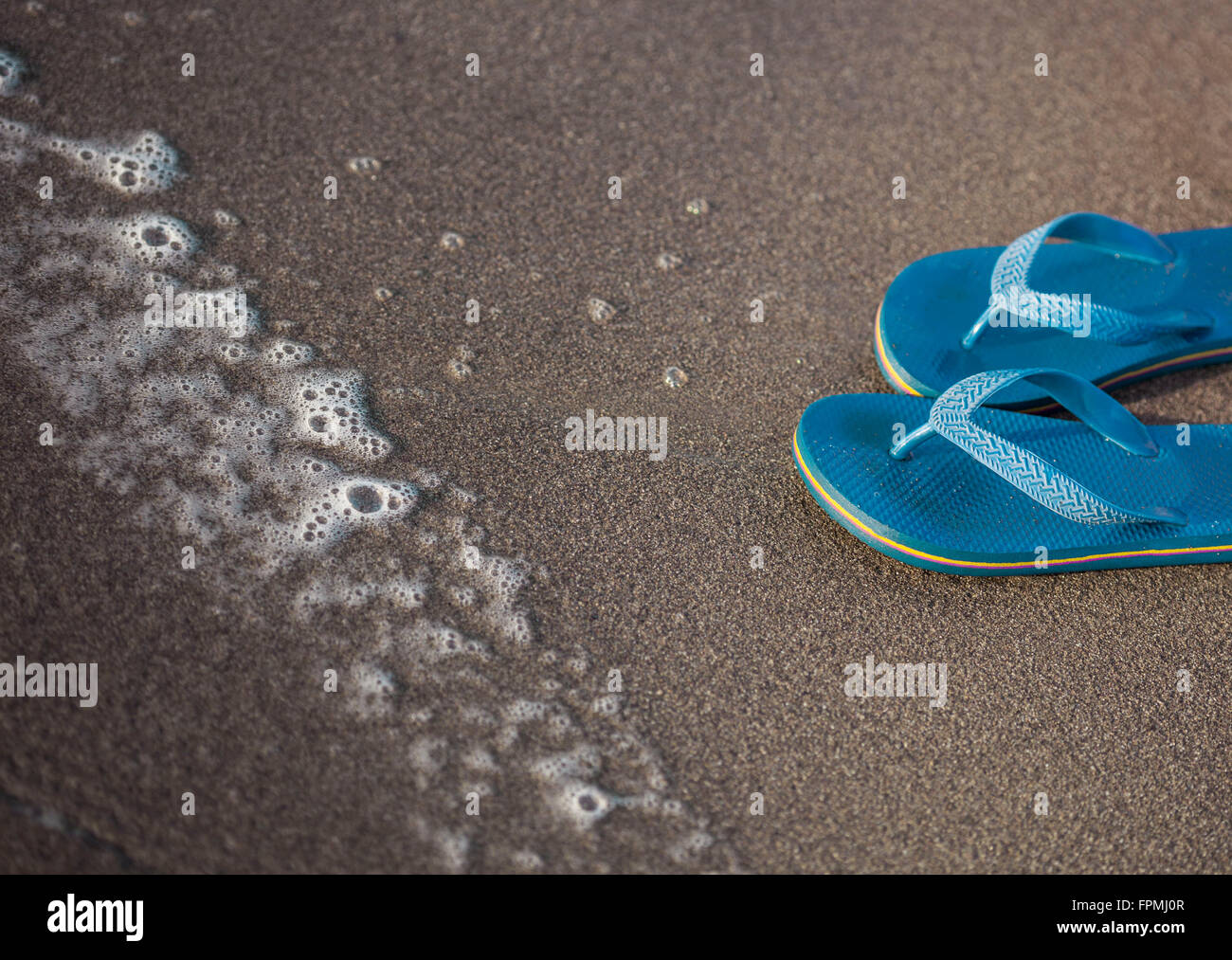 Flip flops on the beach Stock Photo - Alamy