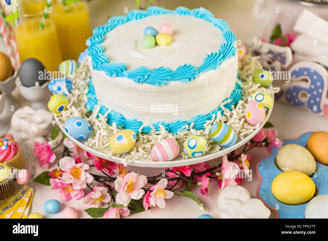 Dessert table set with cake and cupcakes for Easter brunch. Stock Photo