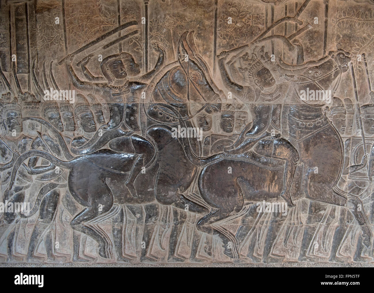 Angkhor Wat, Cambodia - January 29 2016:  Bas relief showing soldiers on horses with swords in the army of 11th Century Suryavar Stock Photo