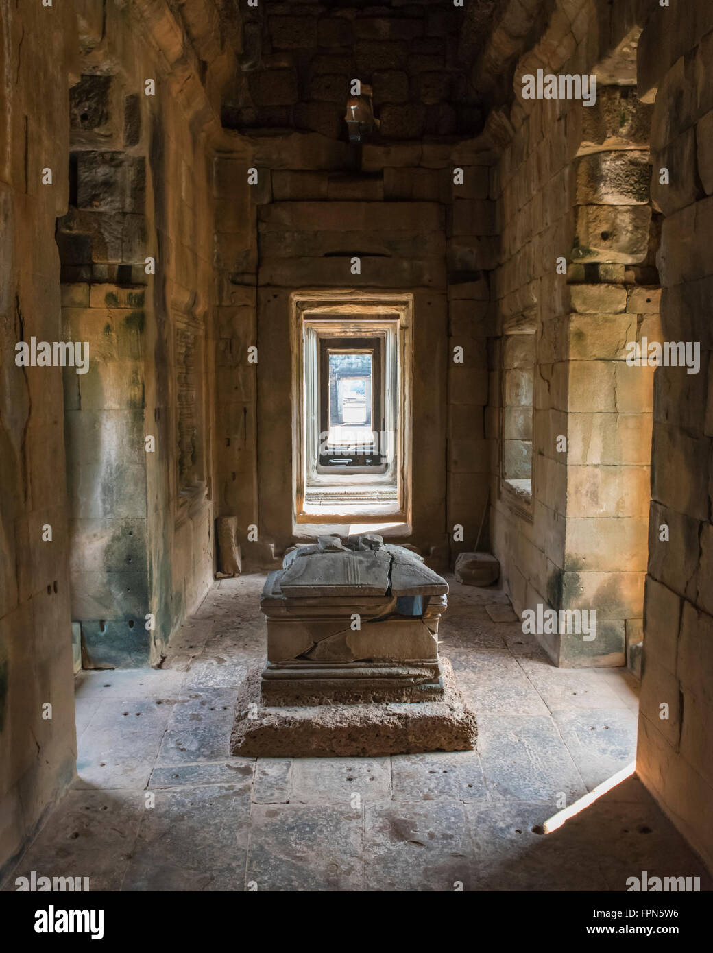 Interior of the Temple of Banteay Samre with a yoni pedestal and showing a long straight corridor to the outside Stock Photo