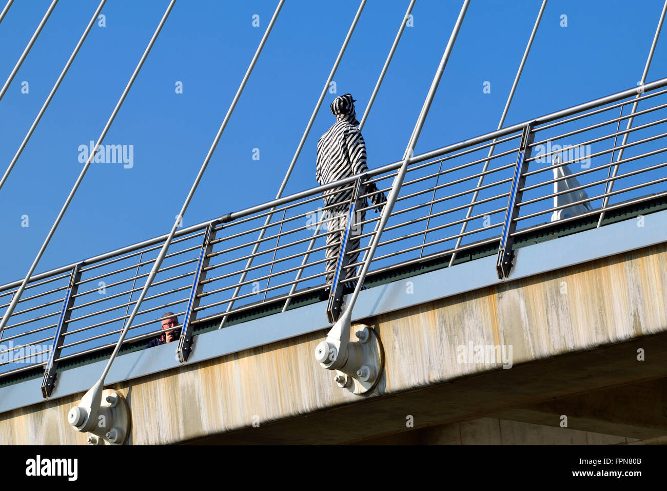 London, England, UK. 'Human Statue' on the Golden Jubilee Bridge (London Bridge) Stock Photo