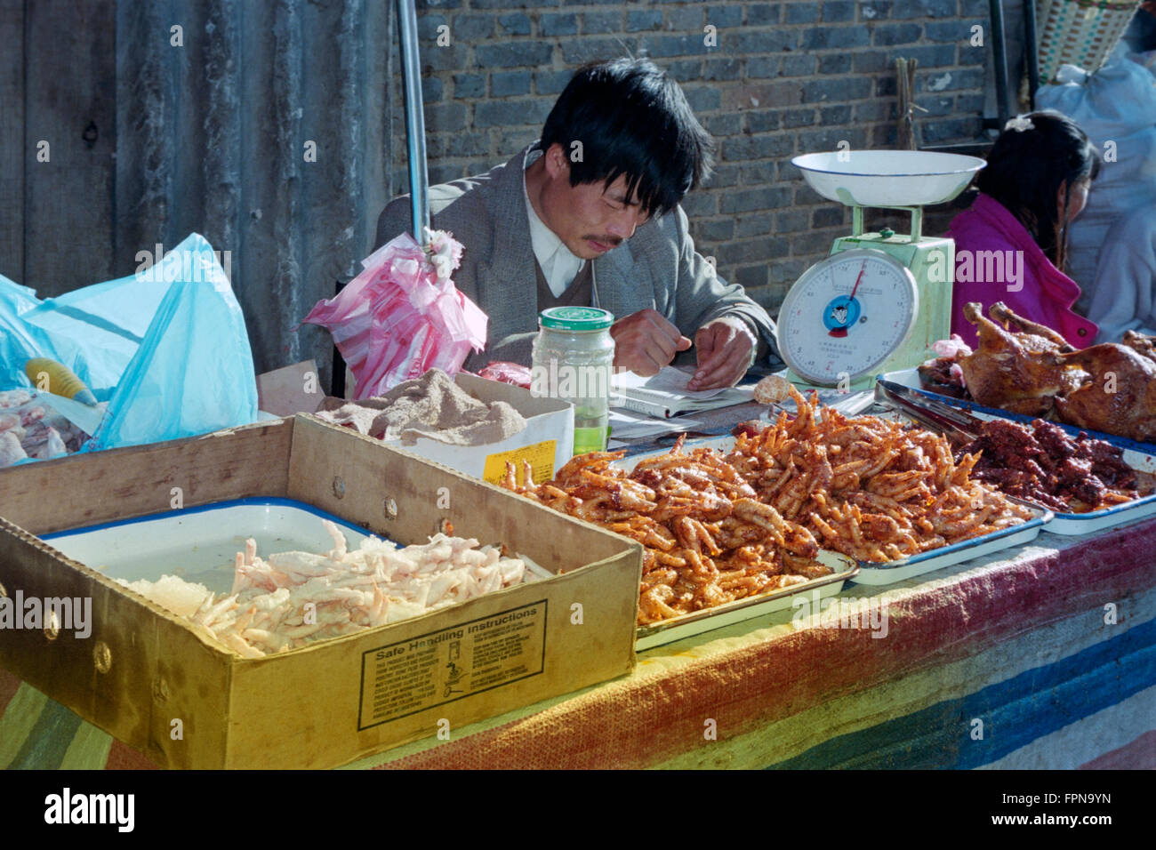 local man at his chicken stall at market in yunnan province china Stock ...