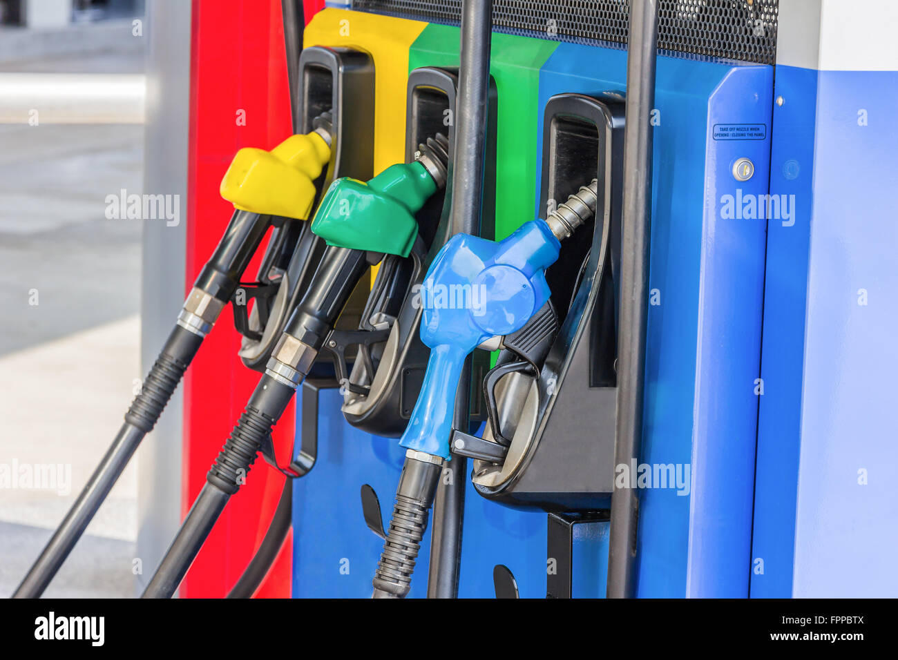 Gas pump nozzles in a service station Stock Photo