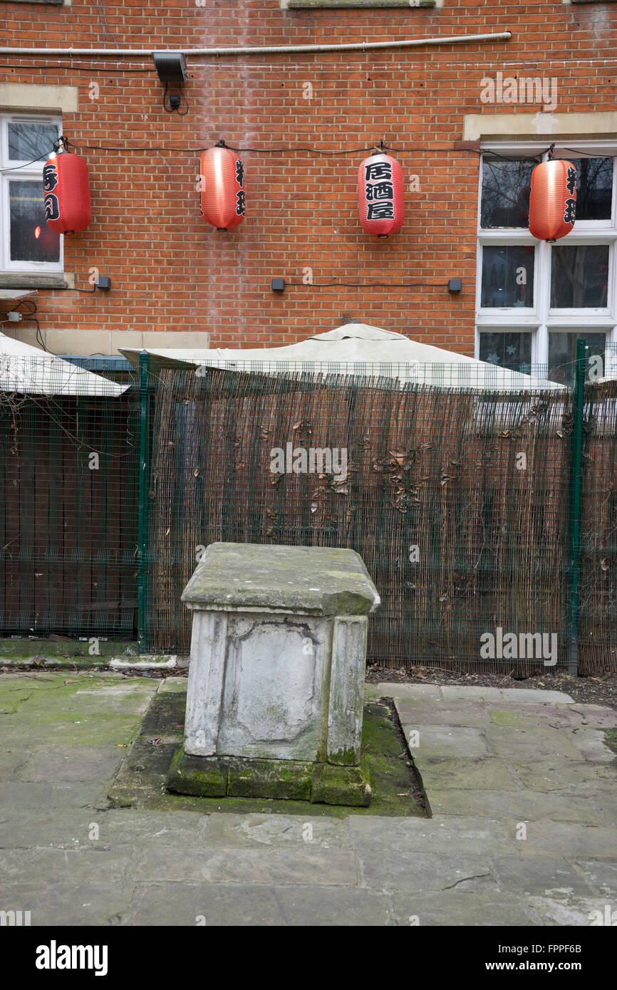 Graveyard with Chinese restaurant in background at the  Altab Ali Park in Whitechapel, London Stock Photo