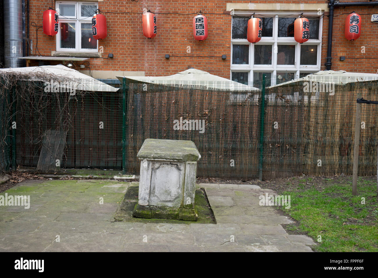 Graveyard with Chinese restaurant in background at the  Altab Ali Park in Whitechapel, London Stock Photo