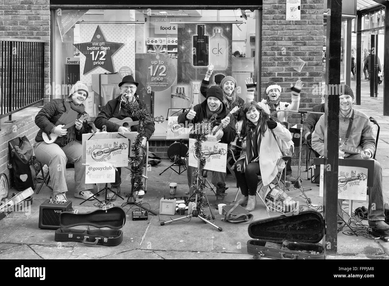 Christmas scene at York UK. Traditional street buskers acknowledging the photographer enjoying Christmas festivities Stock Photo