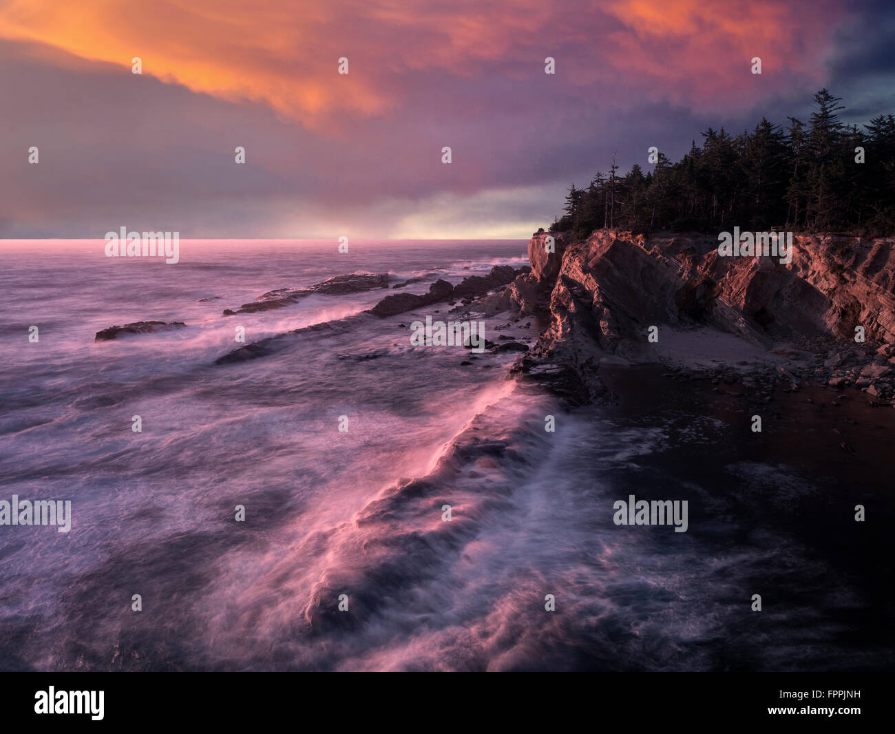 Rock formations,  waves and sunset at Shore Acres State Park, Oregon Stock Photo