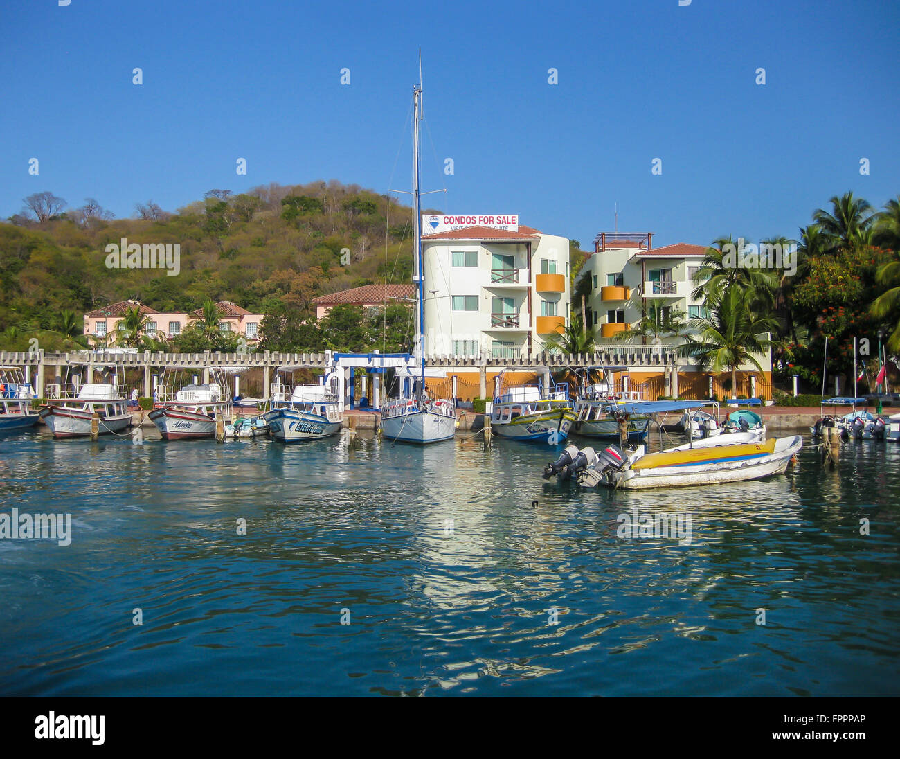Huatulco, Mexico- Boats in the harbor await tourists and excursion seekers in this small cruise ship port in southern Mexico. Stock Photo