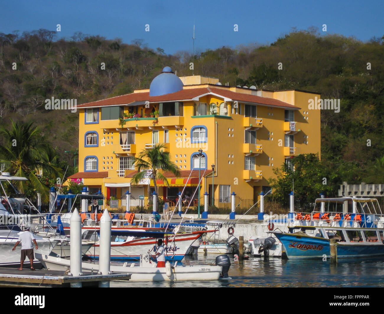 Huatulco, Mexico; Boats in the harbor await tourists and excursion seekers in this small cruise ship port in southern Mexico. Stock Photo