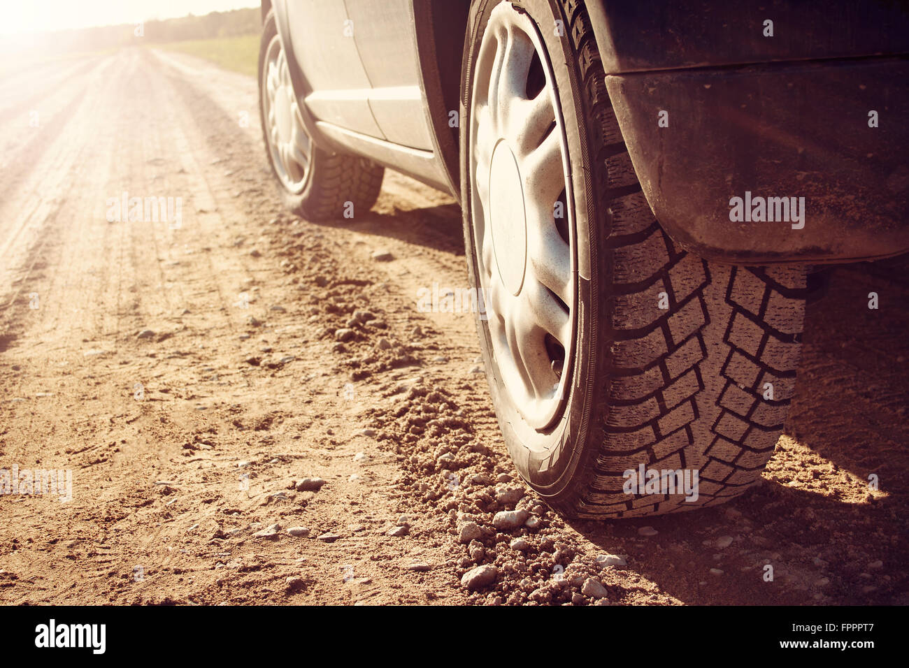 car tire on dirt road Stock Photo