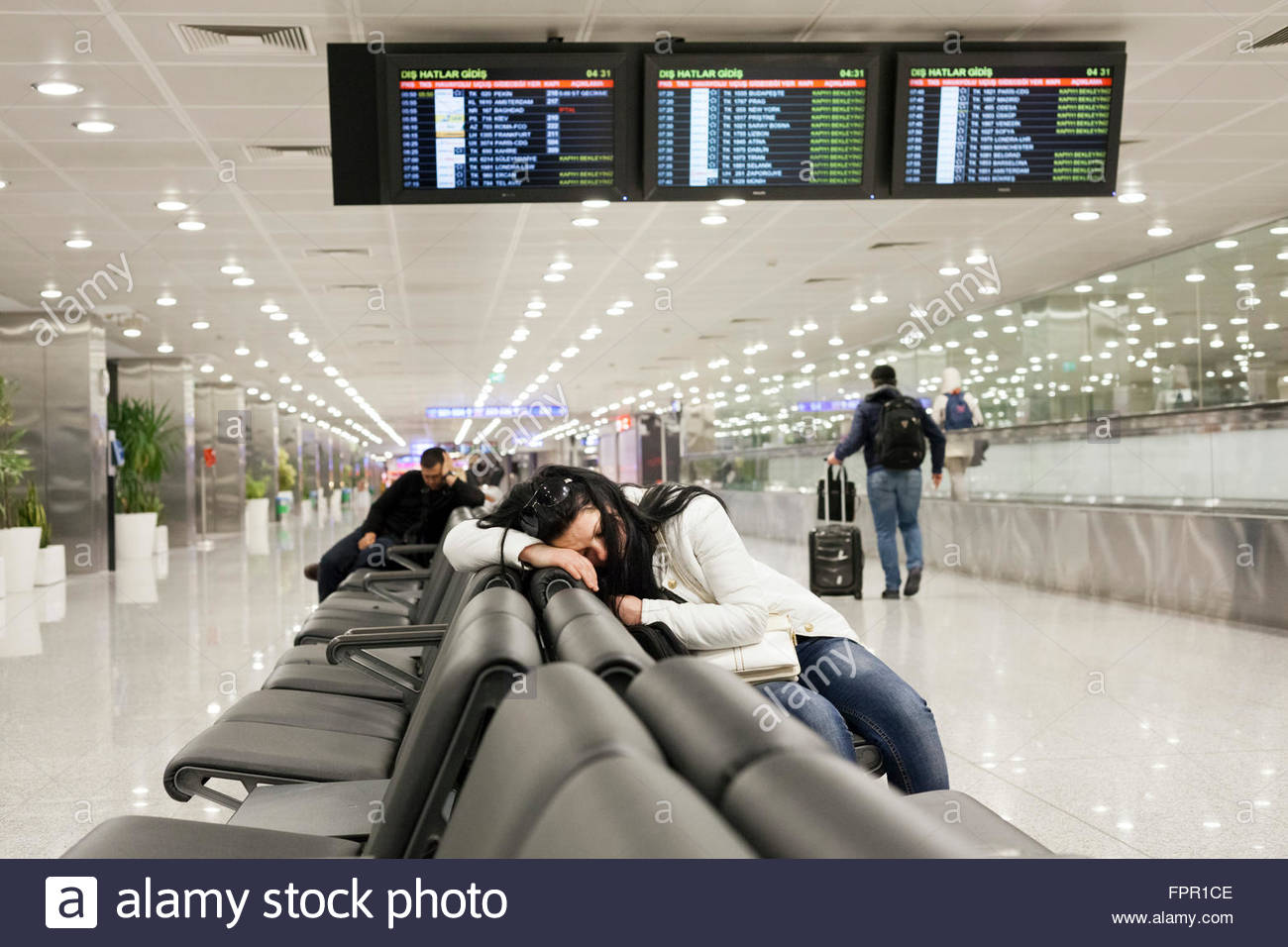 Sleeping At An Airport Stock Photos & Sleeping At An Airport Stock