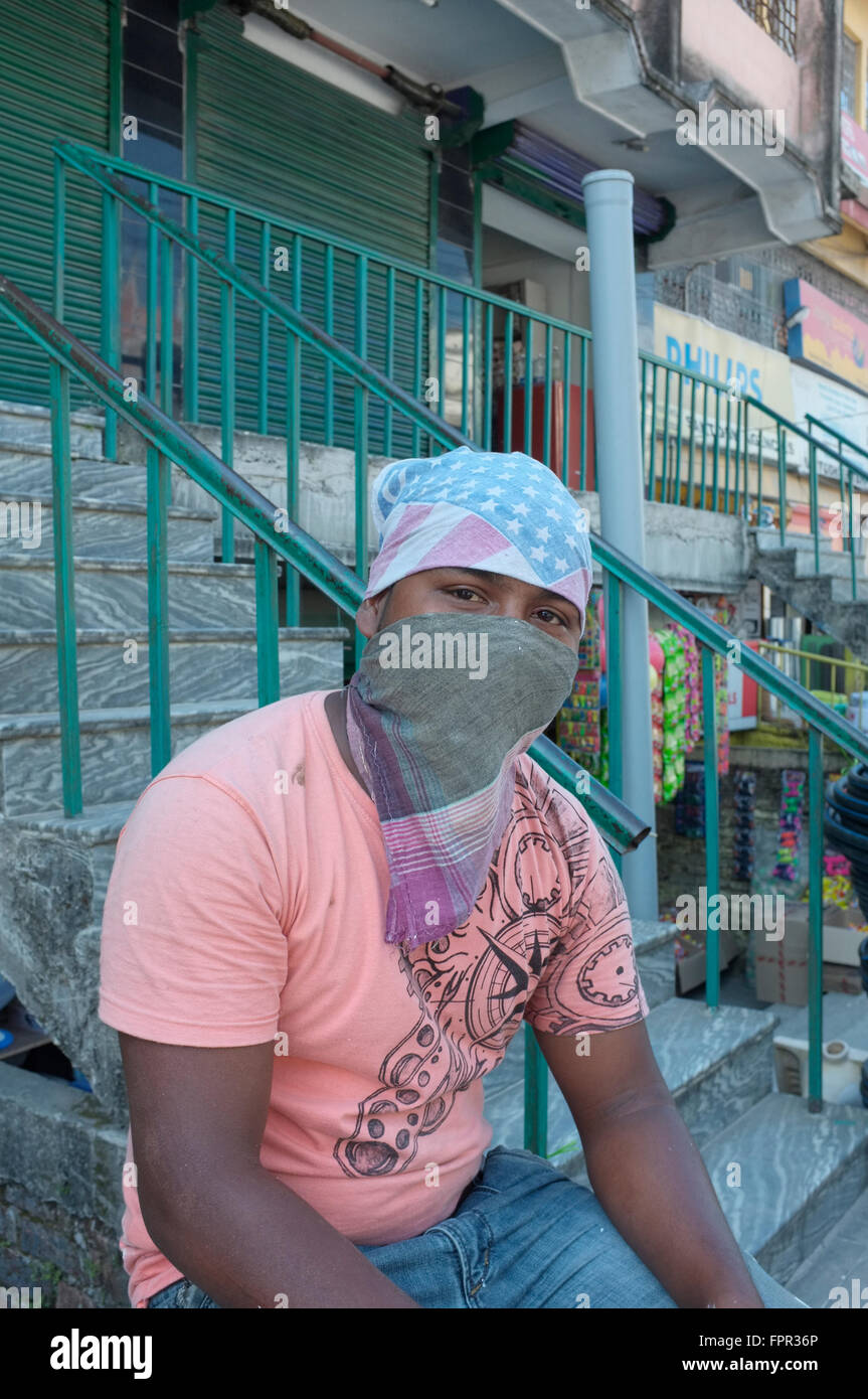 A workman wearing a bandana and face mask. Jaigaon, West Bengal, India. Stock Photo