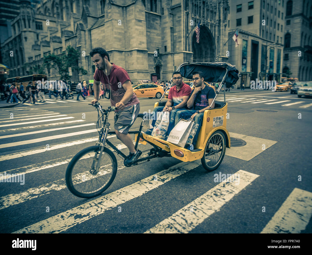Bicycle Rickshaw with passengers on 5th Avenue, New York, USA. Stock Photo