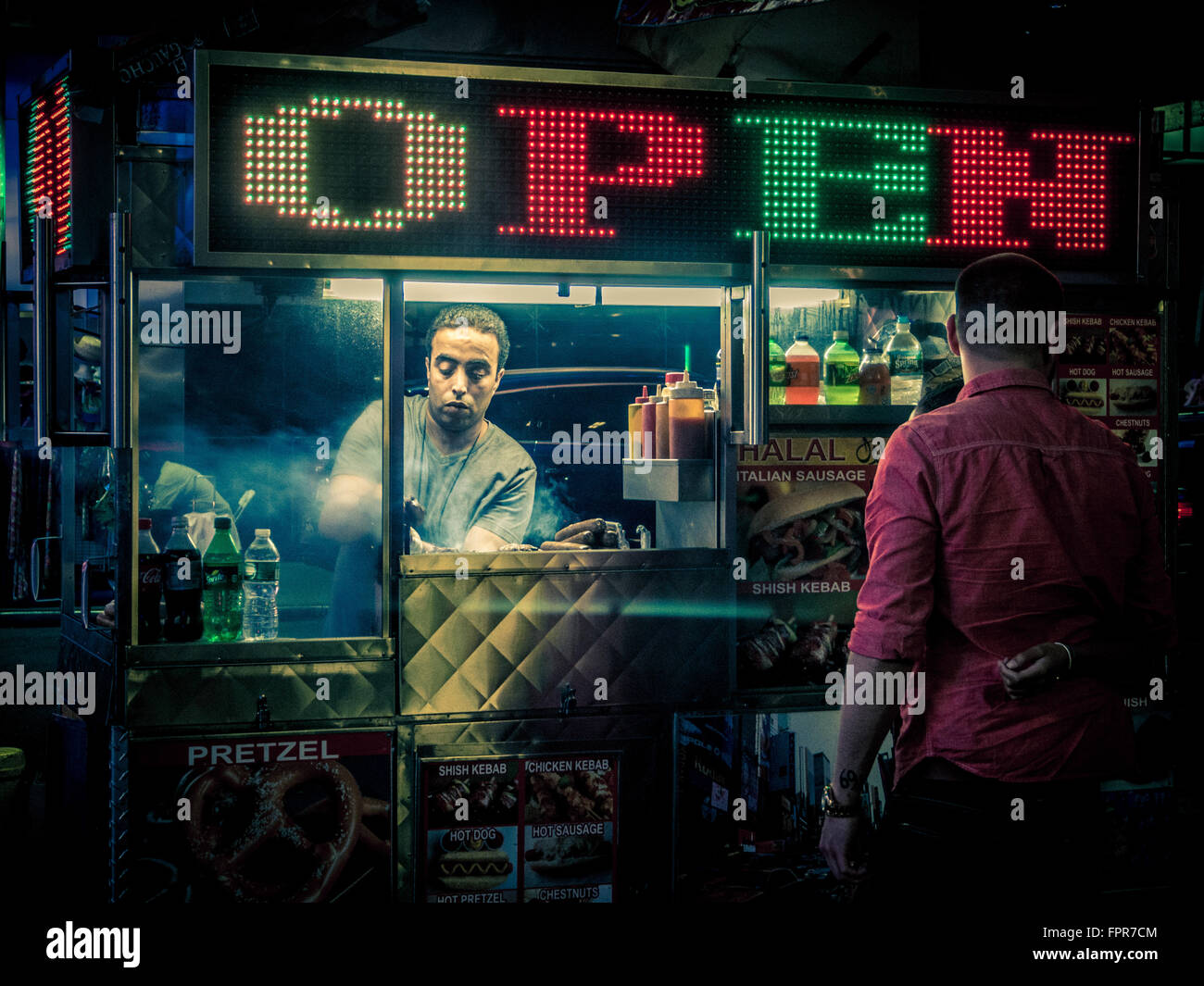 Street food seller in Times Square at night, New York City, USA. Stock Photo