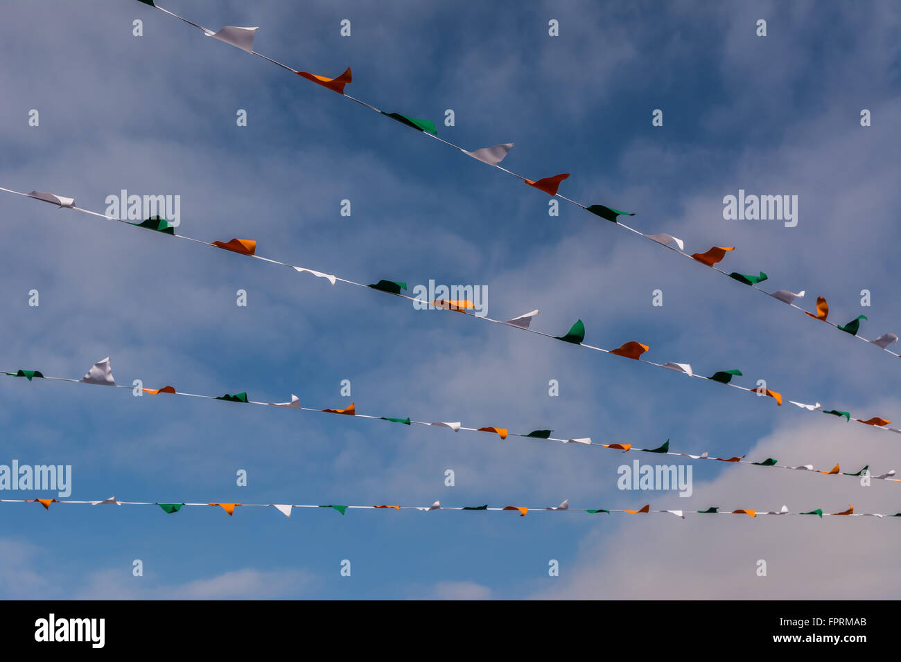 Irish Tricolour bunting flies overhead on Belfast's Falls Road. Stock Photo