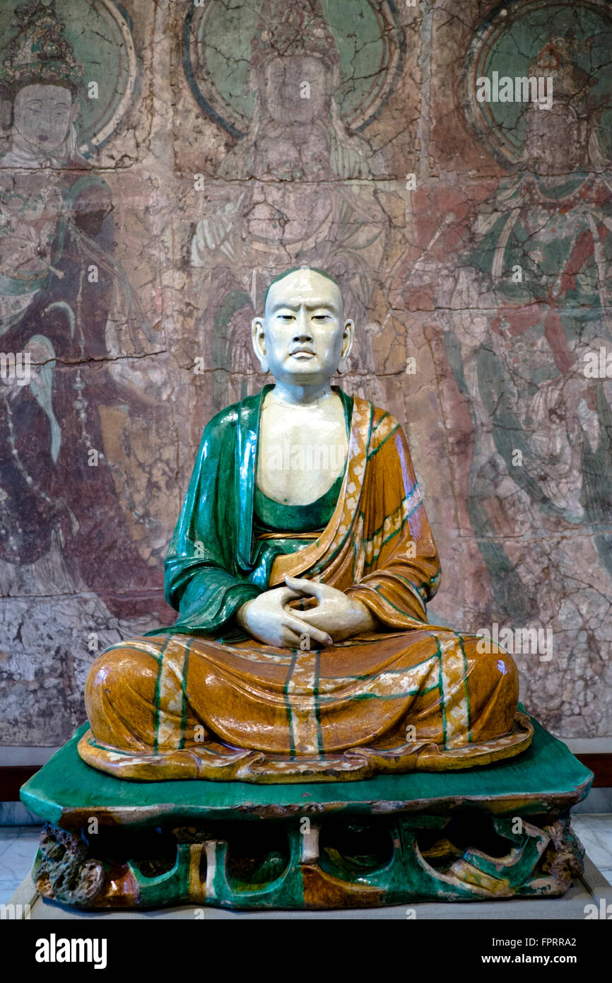 China, Hebei. Life-size, seated figure of a 'luohan' (arhat) Liao dynasty (907-1125 CE), lead-glazed stoneware, British Museum, London. Stock Photo