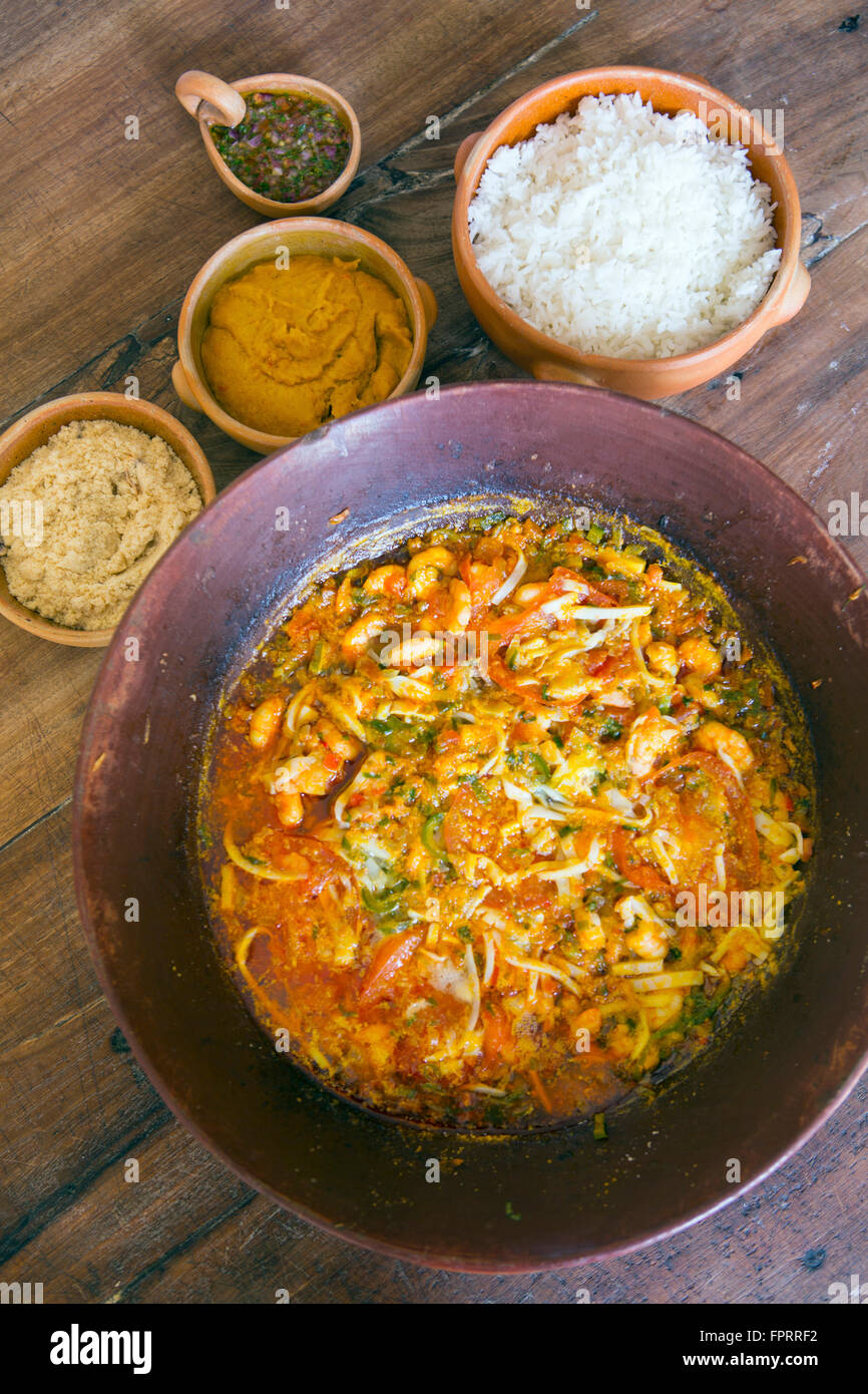 Brazil, Bahia, Seafood moqueca - a traditional Bahian seafood stew served with vatapa, rice, chilli sauce and manioc farofa Stock Photo