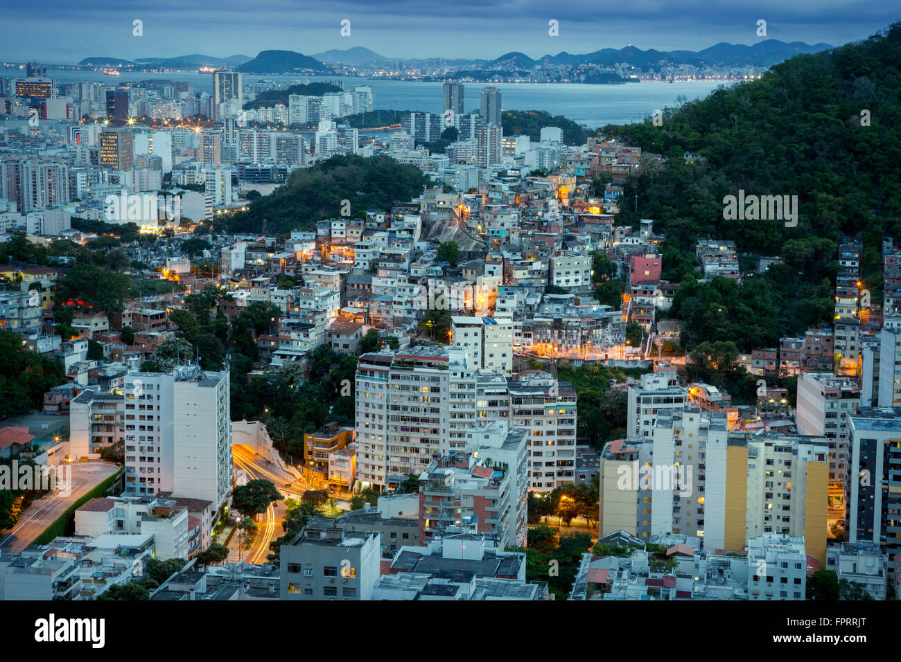 Elevated night view of the Tabajaras favela and Botafogo neighbourhood with Guanabara Bay, Rio de Janeiro, Brazil Stock Photo