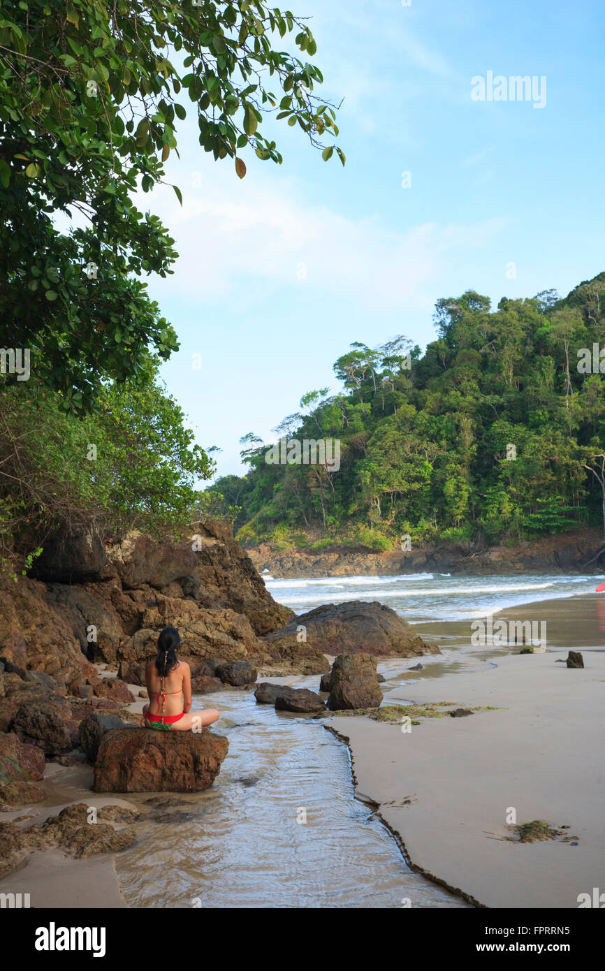 A woman in her thirties meditating on Ribeira beach Itacare, Bahia, Brazil Stock Photo