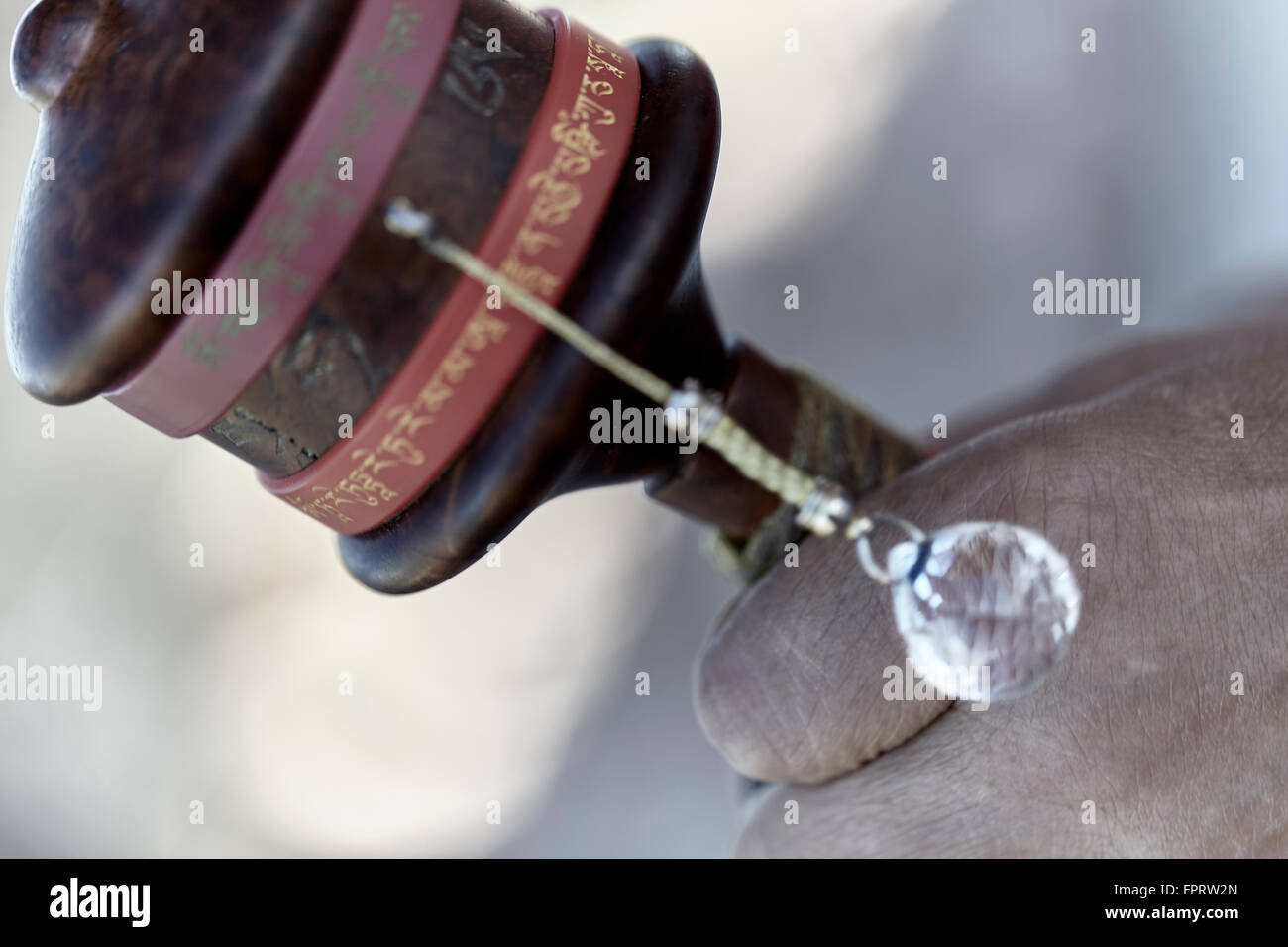 Rinpoche monk with traditional sutra prayer wheel closeup Stock Photo