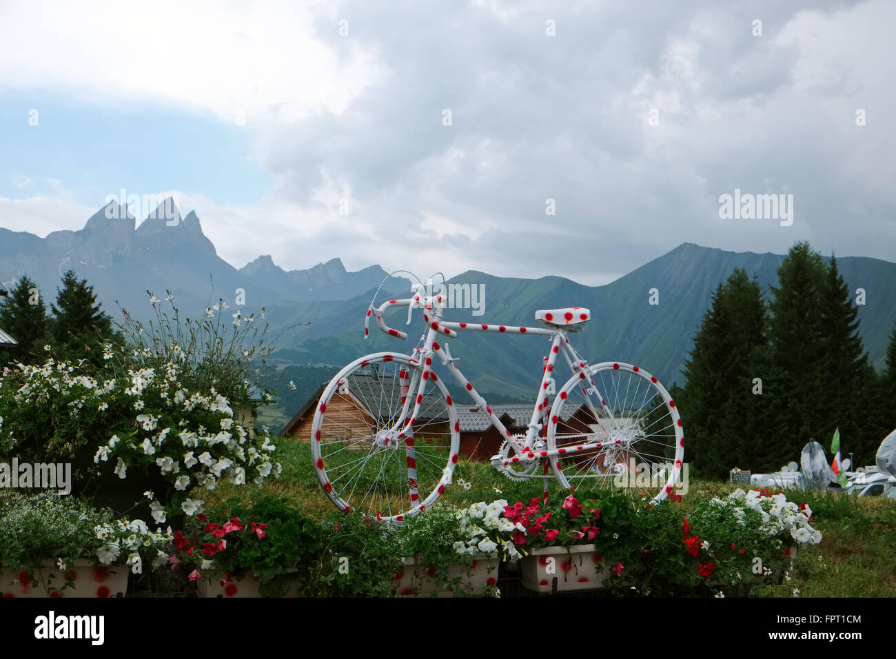 a polka dot painted racing bike put up in the french alps, as an eye catcher for the tour de france Stock Photo