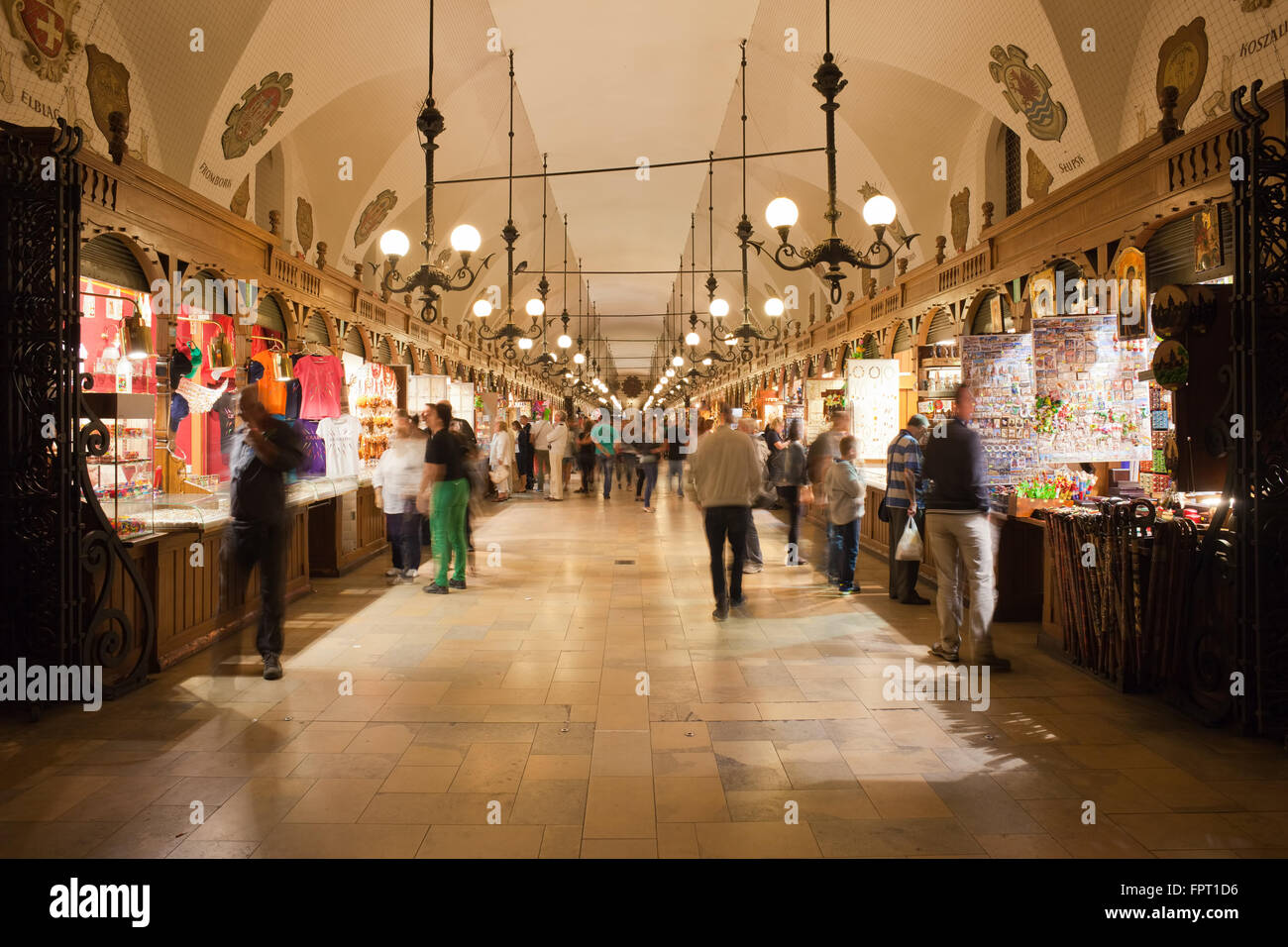 Poland, city of Krakow (Cracow) at night, Sukiennice - Cloth Hall interior with people, tourists Stock Photo