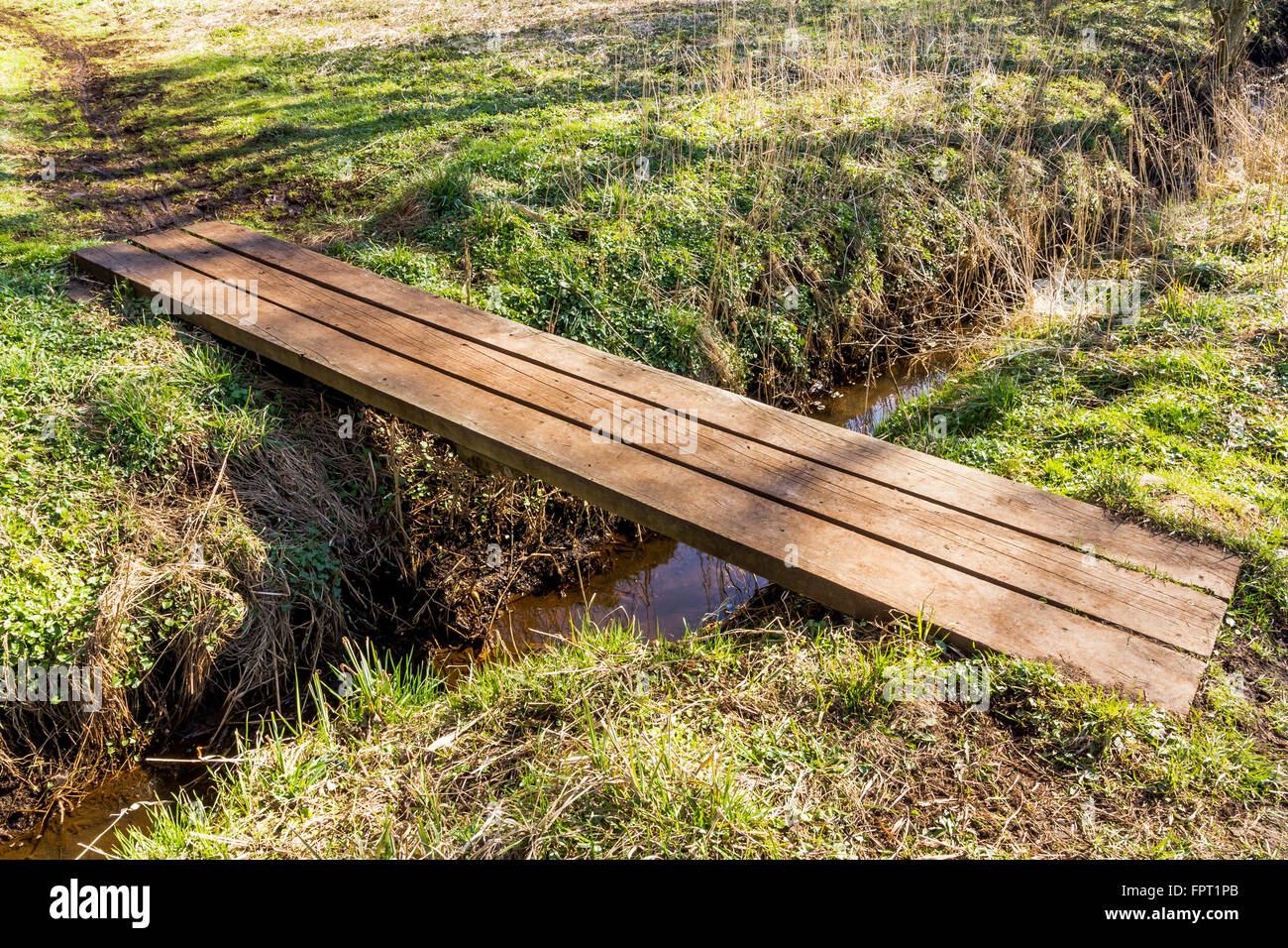 Small simpel bridge over a stream Stock Photo