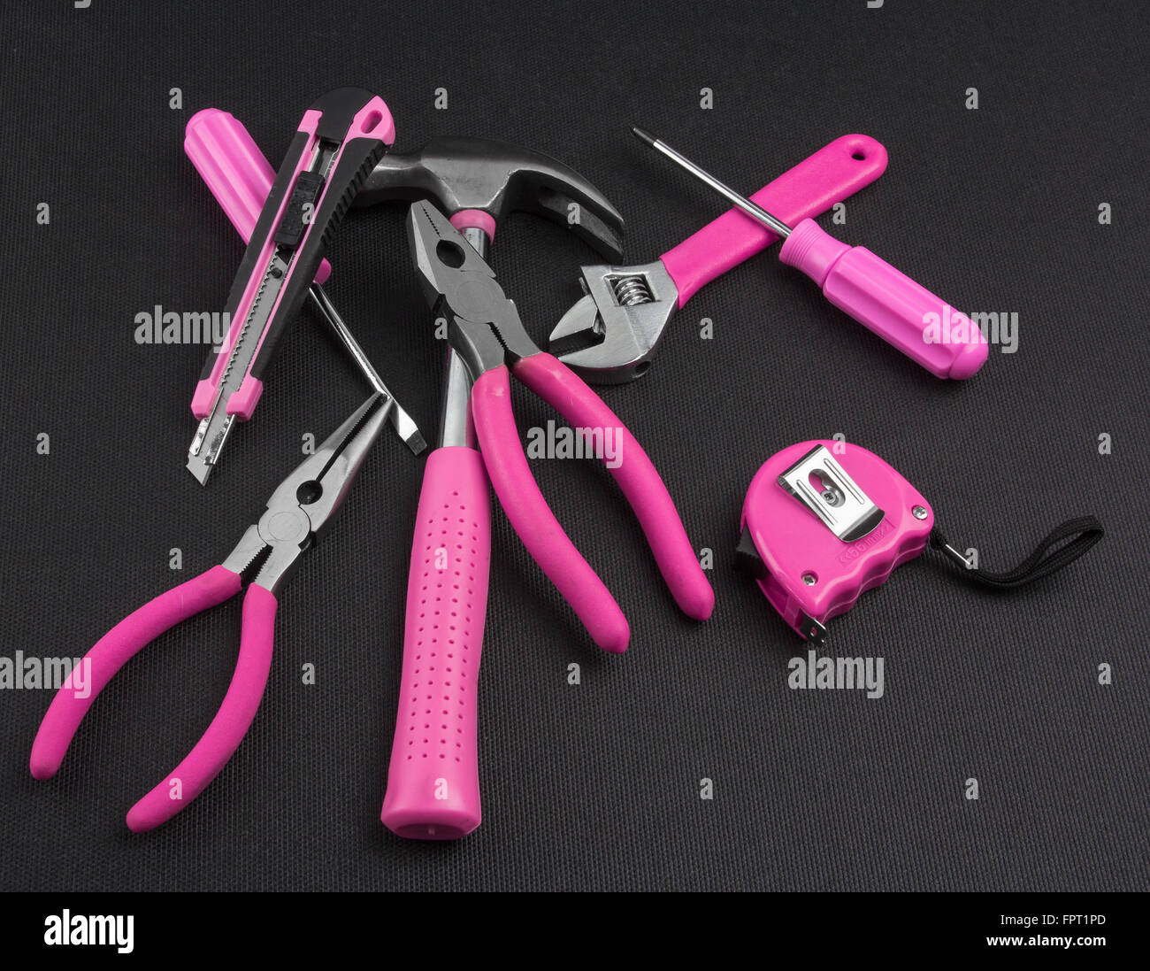 Stack of handy tools with pink handles Stock Photo