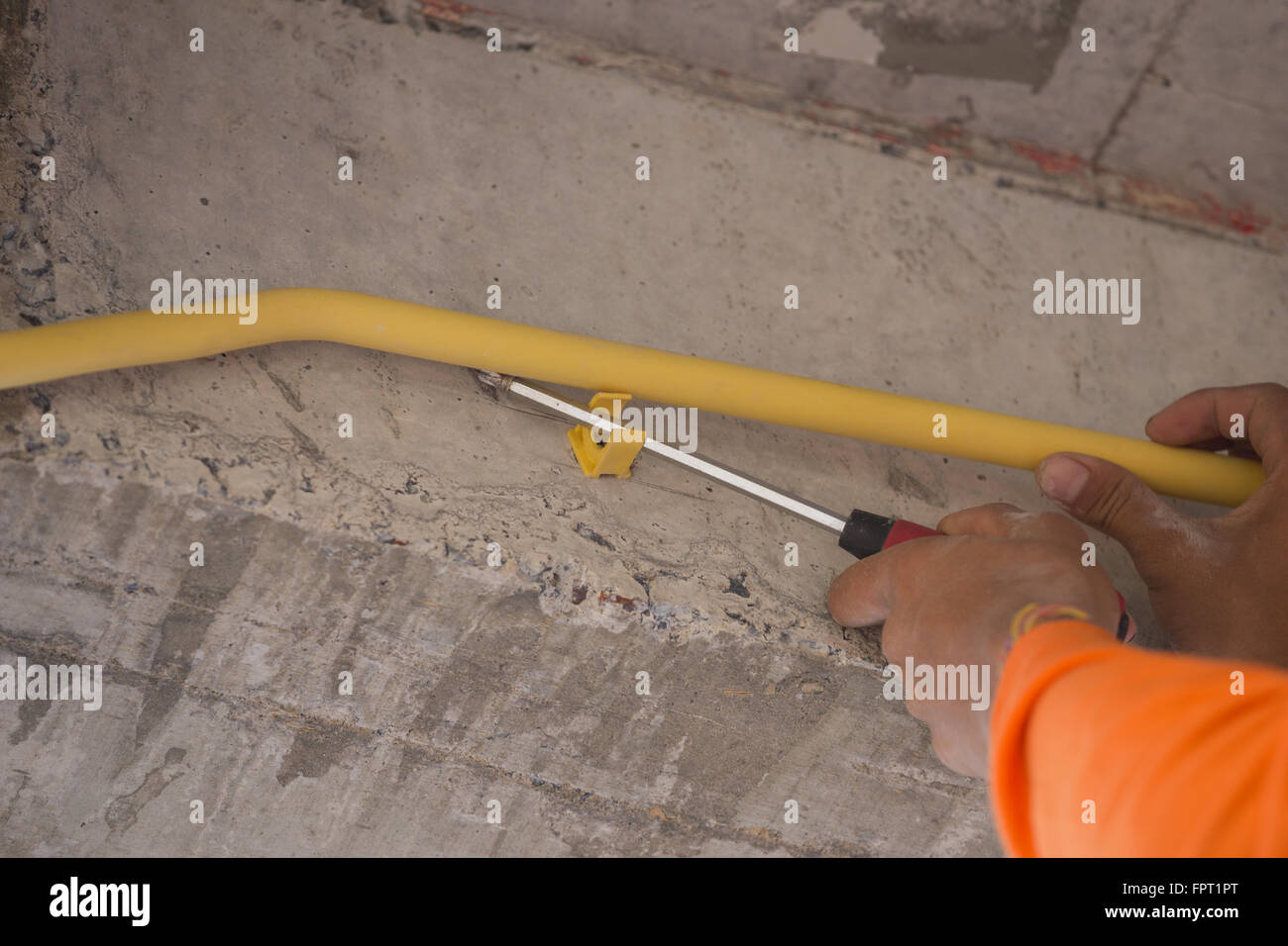 hand of worker install PVC pipes for electric conduit Stock Photo