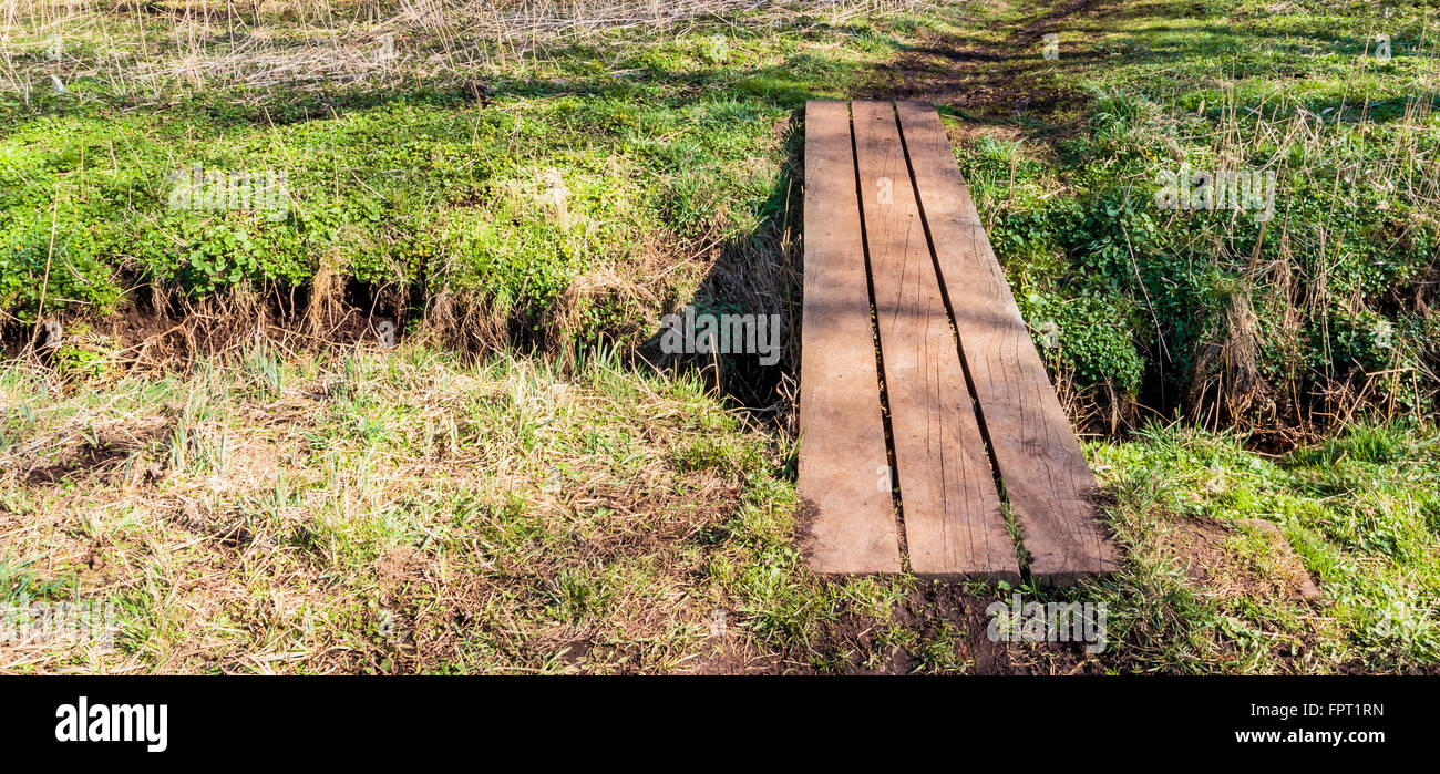 Small simpel bridge over a stream Stock Photo