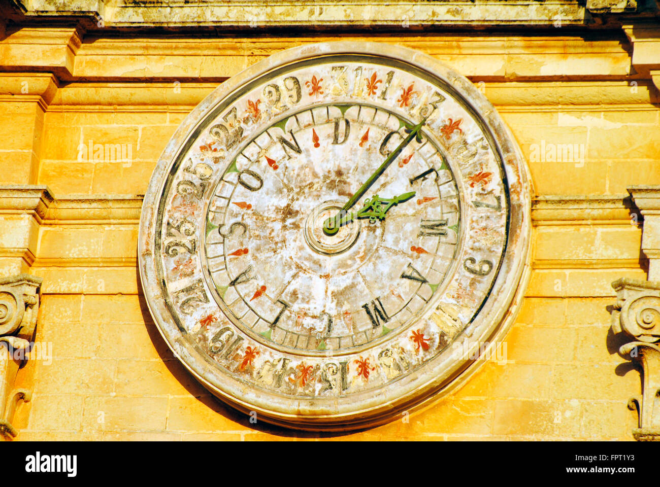 Old wall clock with numeric and alphabetic dial on St Pauls Cathedral