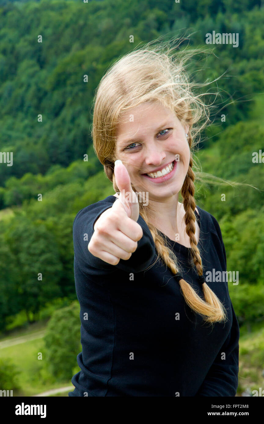 Young, happy woman with thumb up Stock Photo