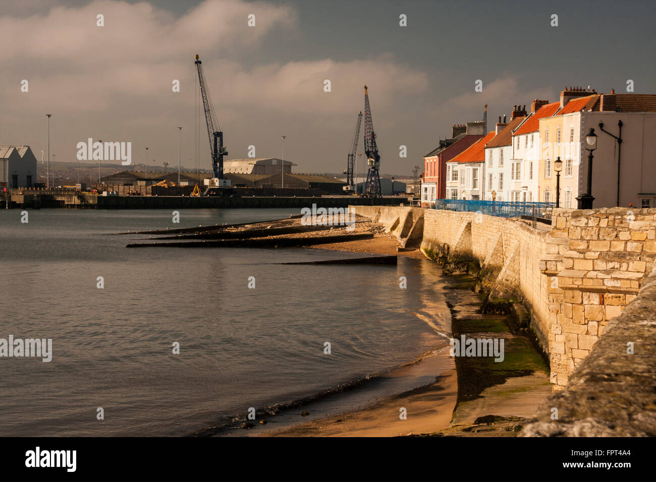 A view of the Headland at Hartlepool in north east England showing the houses, beach and cranes