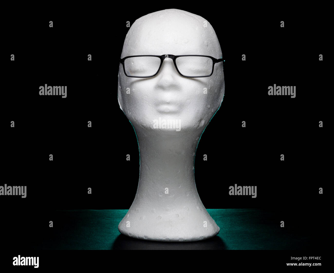 White dummy female head with eyeglasses on black background Stock Photo