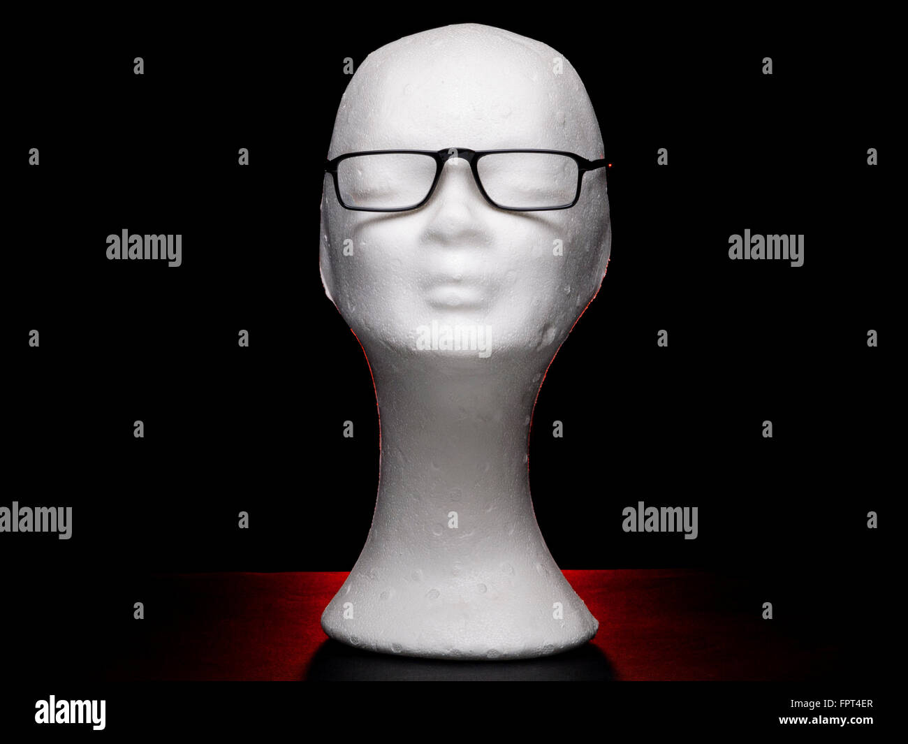 White dummy female head with eyeglasses on black background Stock Photo