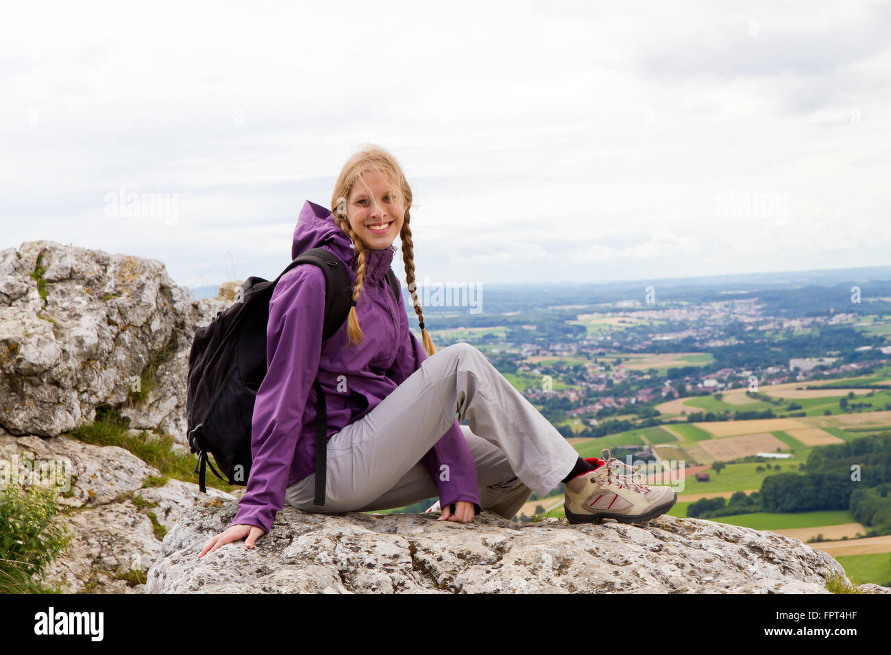 Young happy woman on a mountain peak Stock Photo