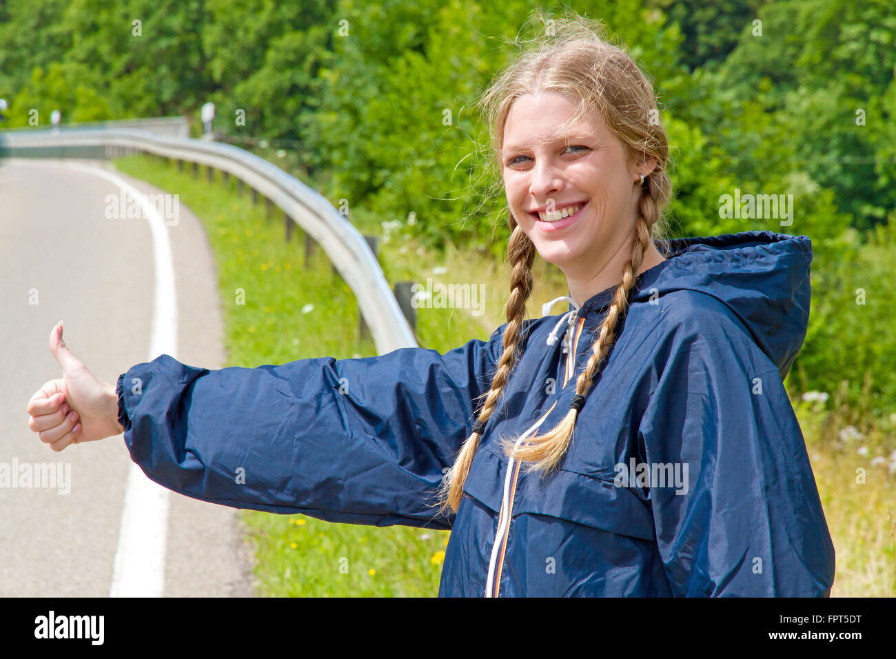 Young woman hitchhiking Stock Photo