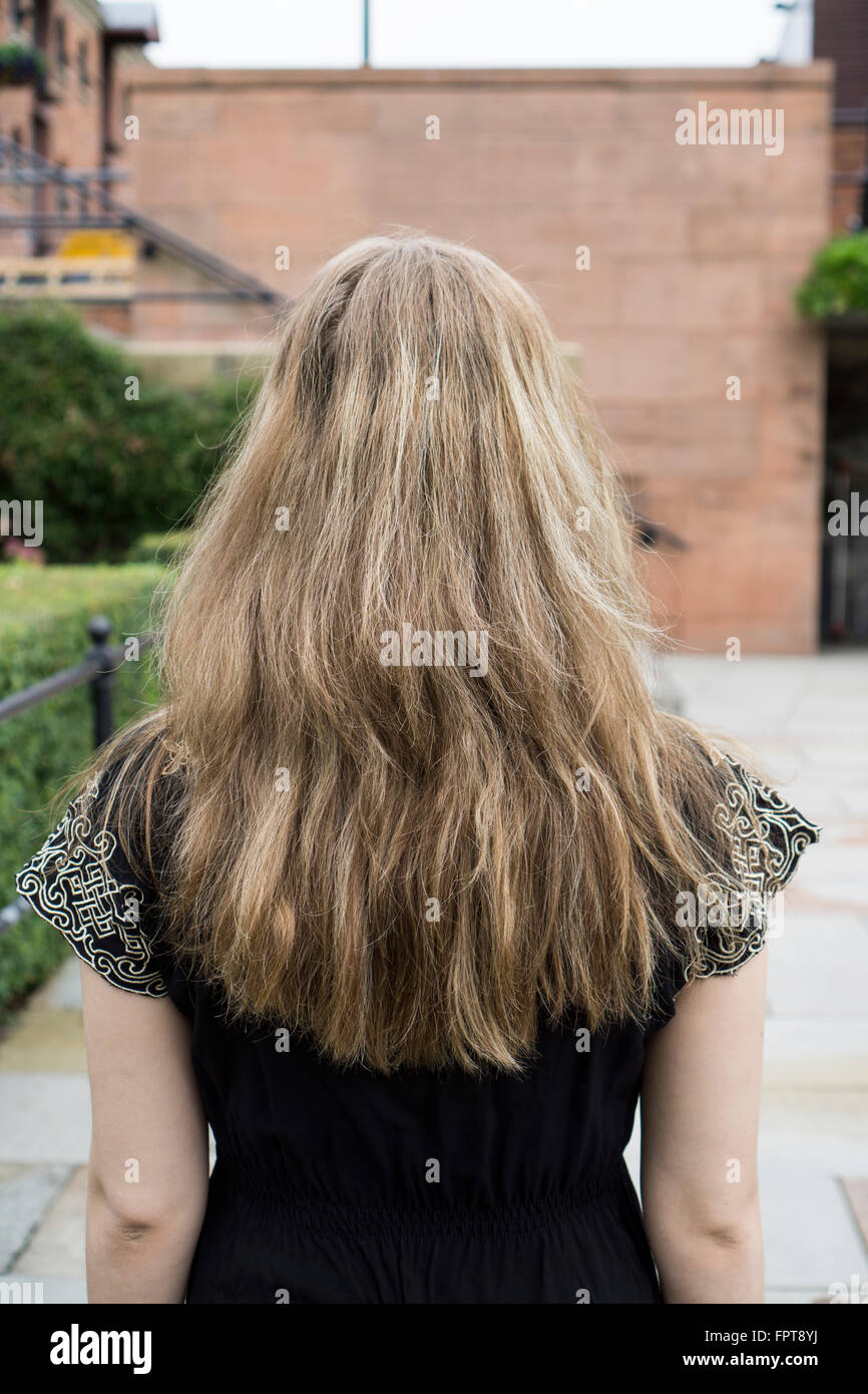 Rear view of a blond woman outdoors Stock Photo - Alamy