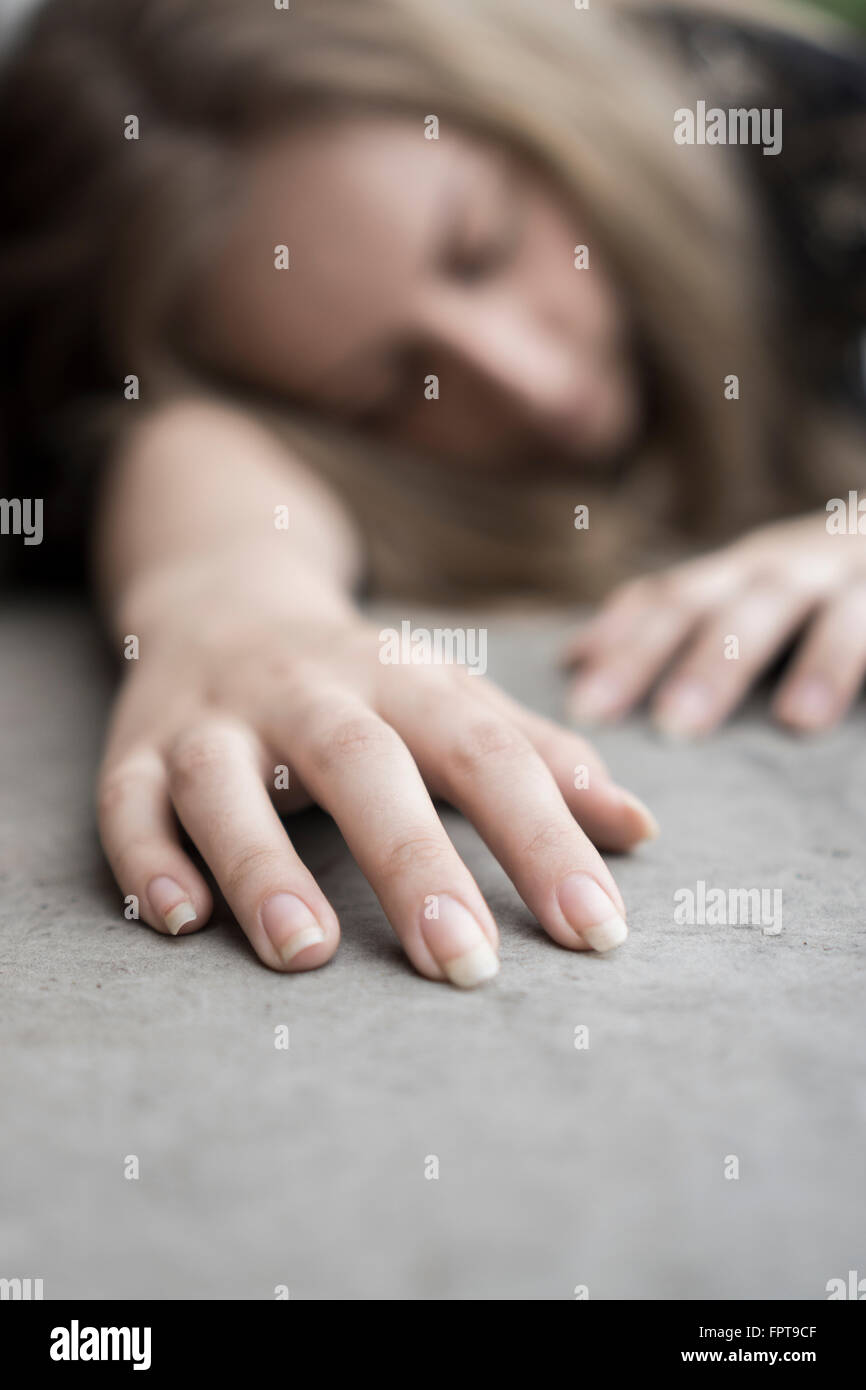 Dead woman on the ground outdoors Stock Photo