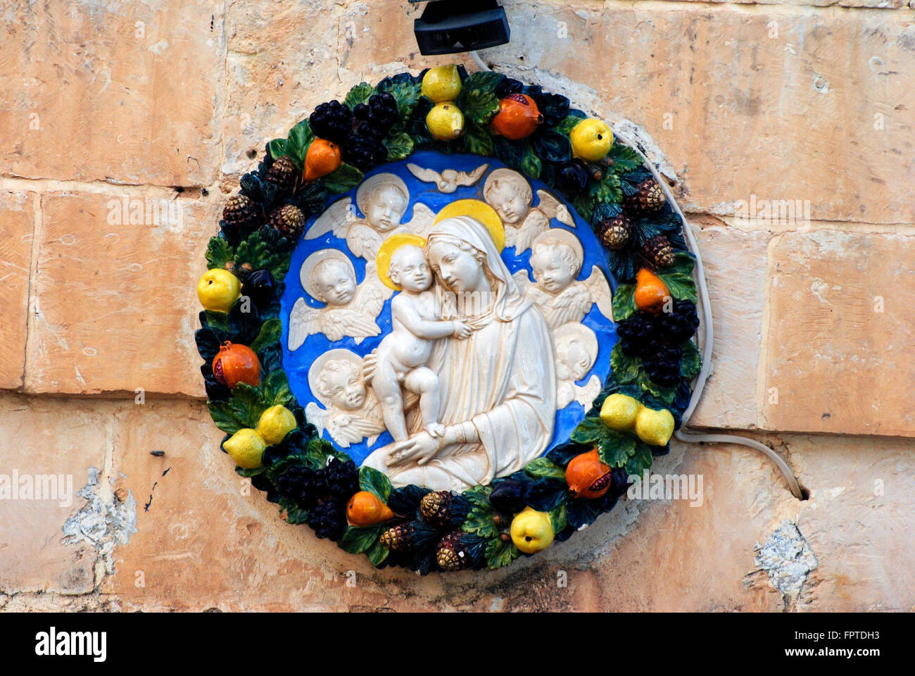 Wall sculpture in Mdina, Malta depicting Virgin Mary with child. Stock Photo