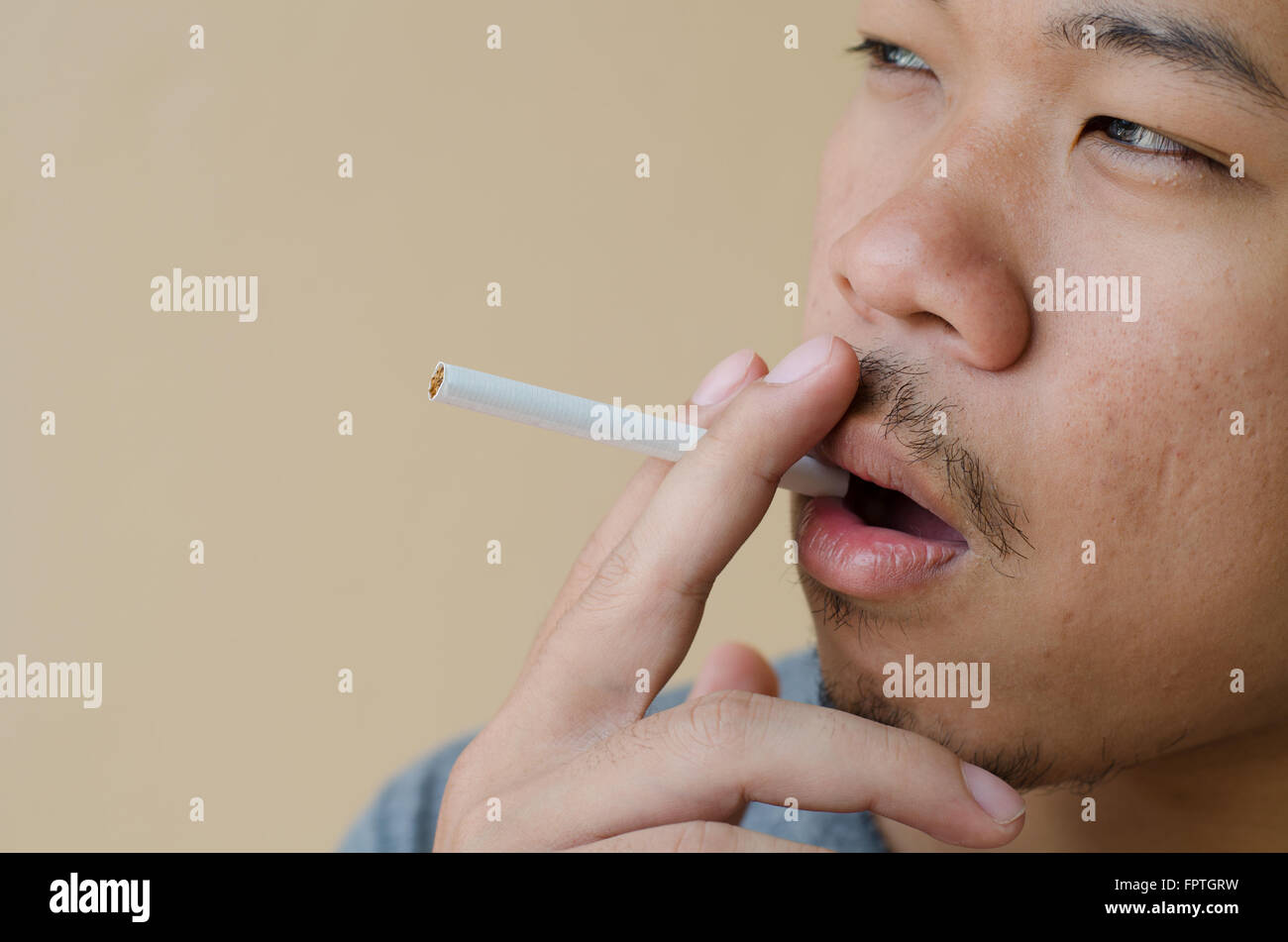 young man smoking a cigarette Stock Photo