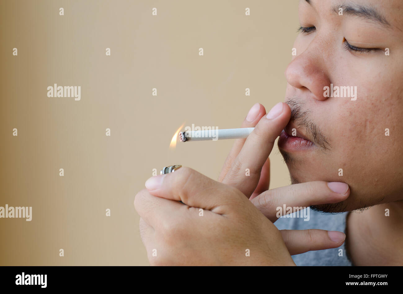 Asian young man smoking cigarette Stock Photo