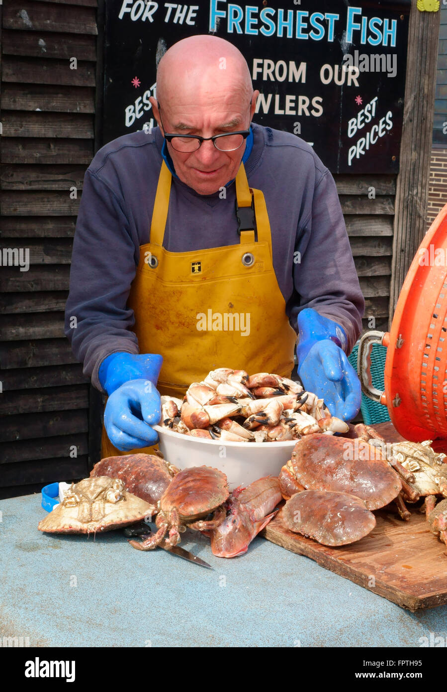 Hastings fisherman preparing crab claws on the stade beach, Hastings seafront, East Sussex, England, UK, GB Stock Photo