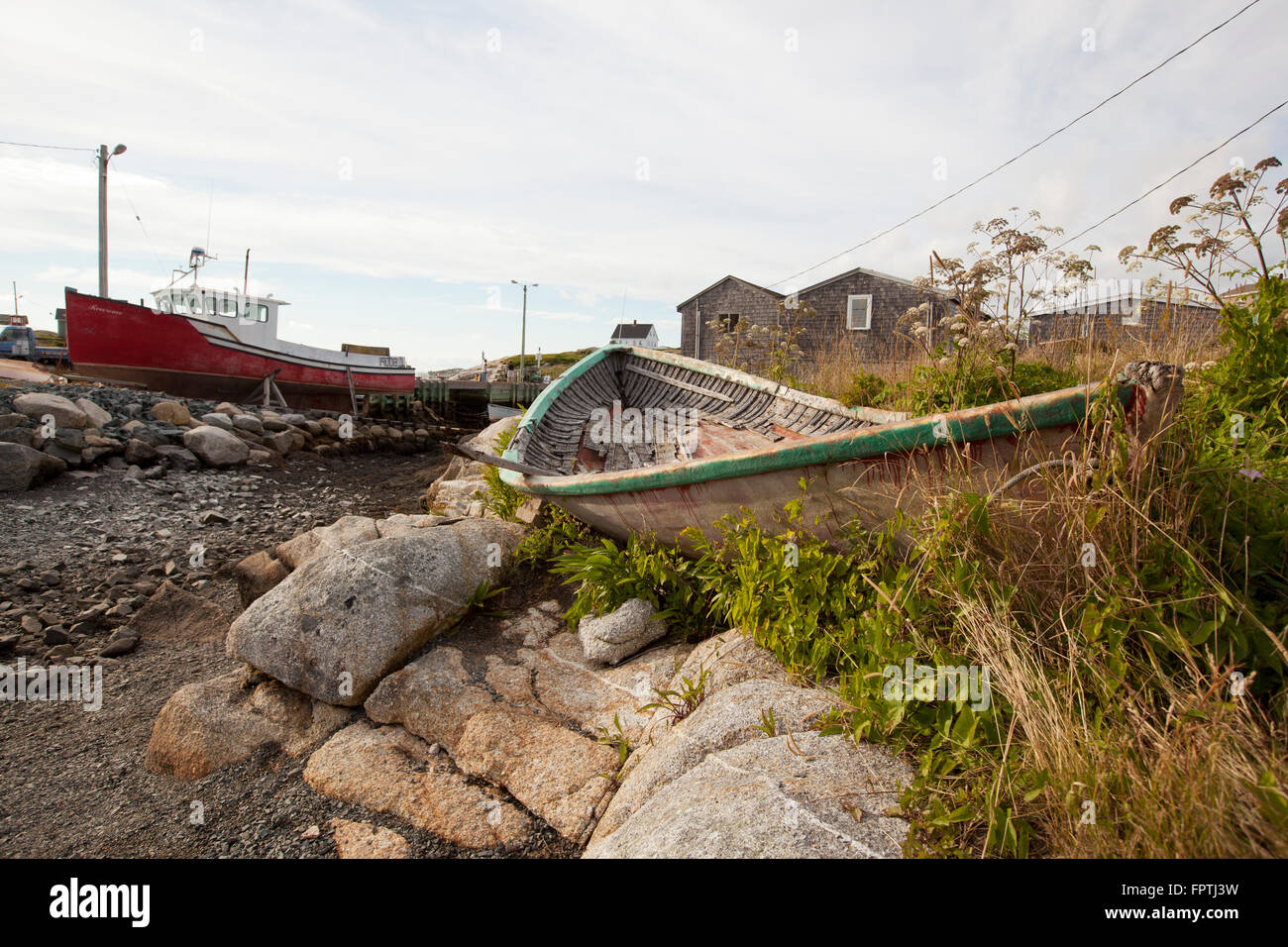 old abandoned wooden boat on rocky beach Stock Photo - Alamy