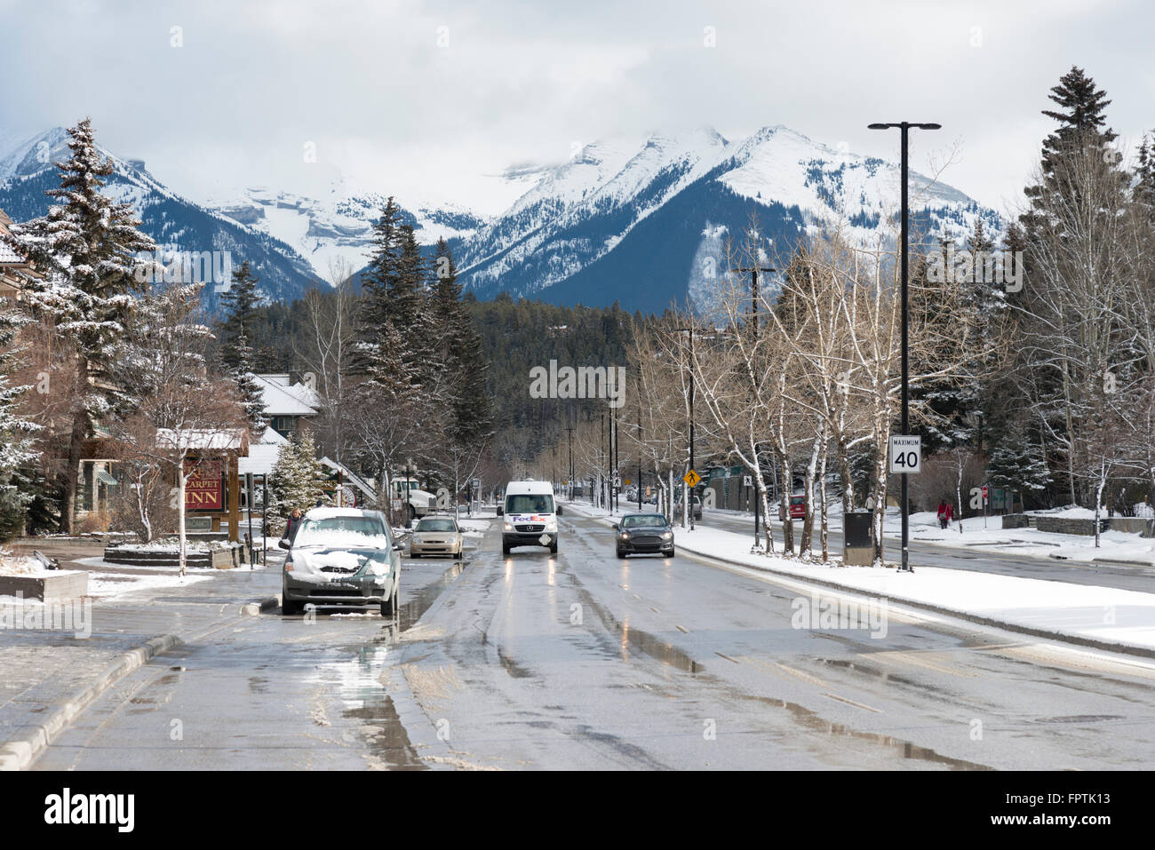 Banff Avenue a road in Banff Canada in winter with views of the Rocky Mountains Stock Photo