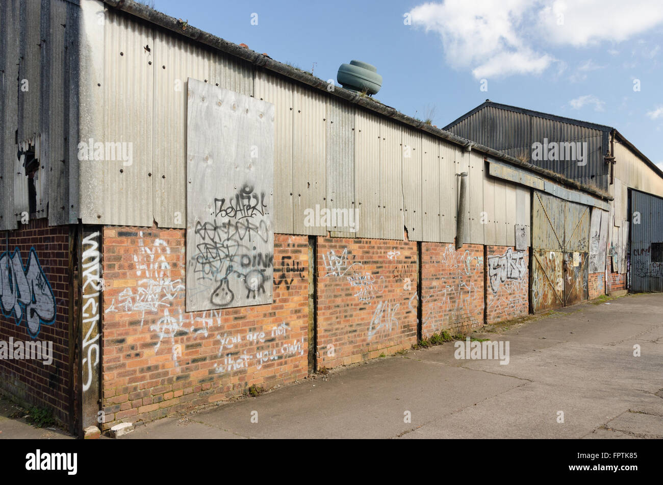 Derelict warehouse covered in corrugated iron on the Stourbridge canal in Stourbridge, West Midlands Stock Photo