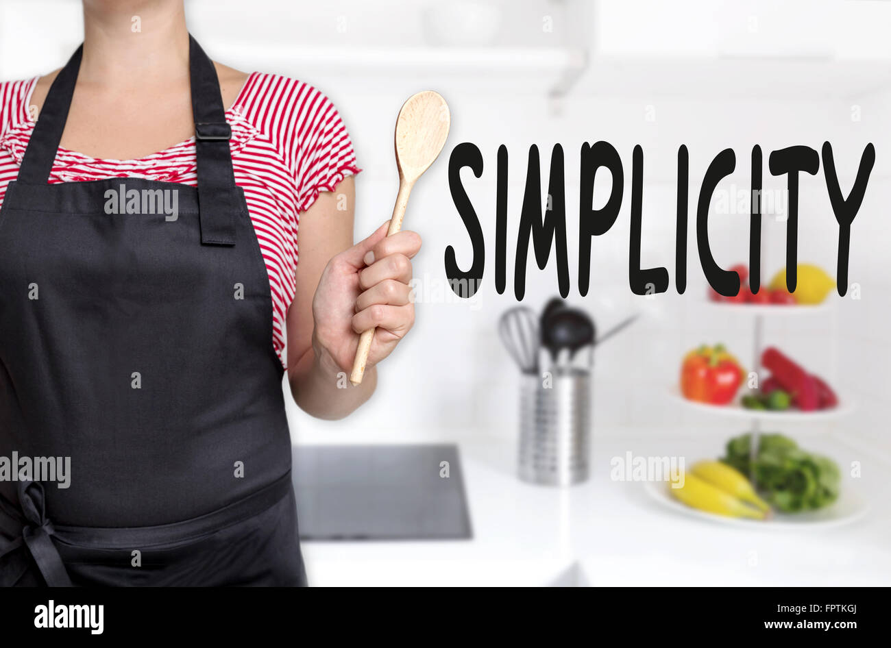 simplicity cook holding wooden spoon concept background. Stock Photo
