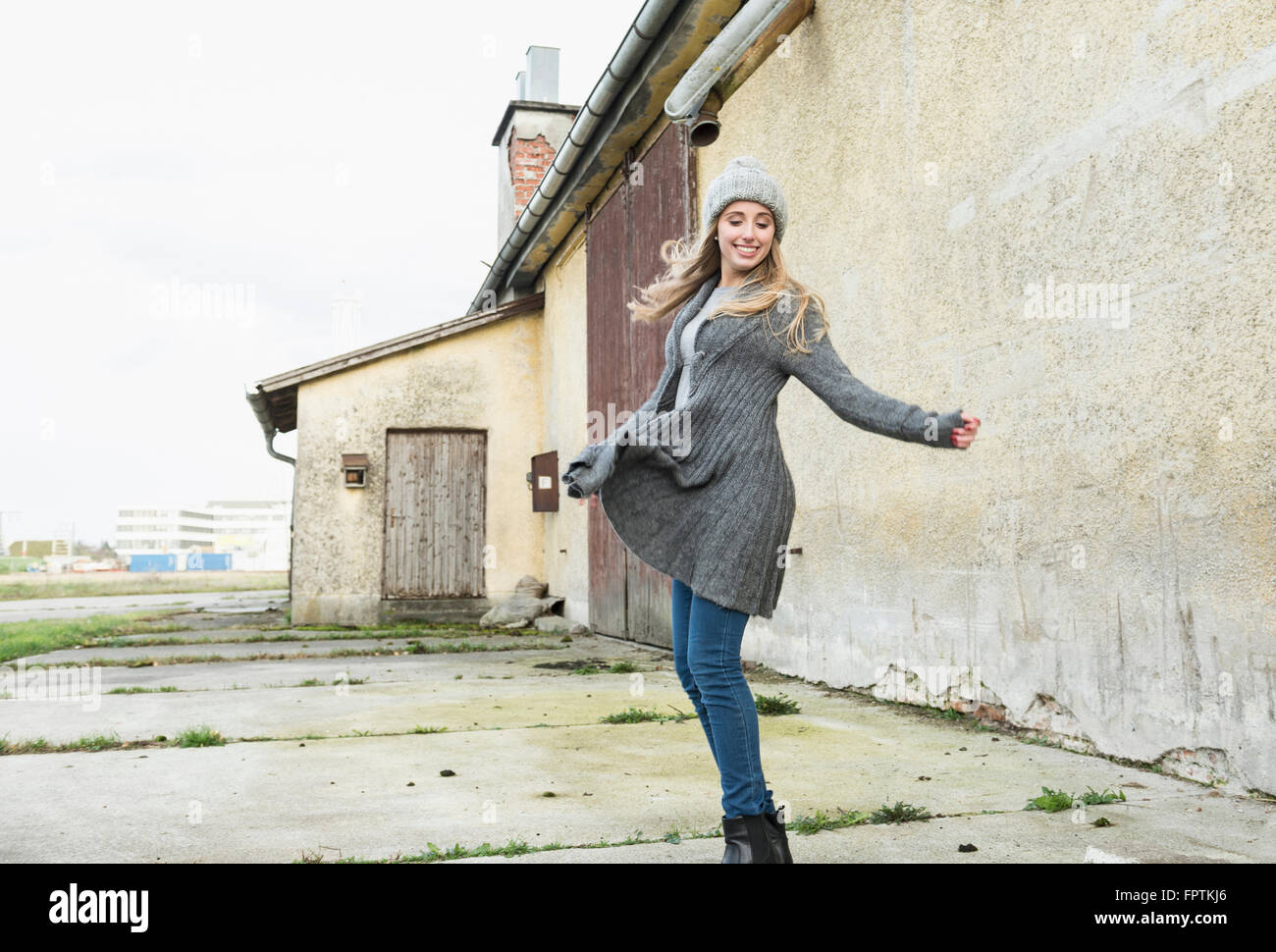 Teenage girl dancing outside of building, Munich, Bavaria, Germany Stock Photo